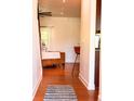 Inviting hallway with hardwood floors that leads to a brightly lit open living space at 1814 Woods Ln, Denver, NC 28037