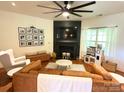 Bright living room featuring a dark fireplace, wooden floors, and stylish decor at 1814 Woods Ln, Denver, NC 28037