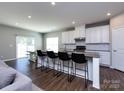 Modern kitchen with granite countertops, white cabinets, and stainless steel appliances at 2018 Sewall Sw Ave, Concord, NC 28025