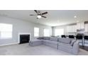 Spacious living room featuring a fireplace, ceiling fan, and a large sectional sofa at 2018 Sewall Sw Ave, Concord, NC 28025