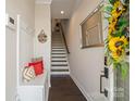 Inviting entryway featuring coat rack, bench, and staircase at 224 Parkwood Ave, Charlotte, NC 28206