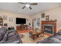 Inviting living room with hardwood floors, a ceiling fan, and a cozy fireplace, perfect for relaxation at 2408 Joes Lake Rd, Shelby, NC 28152