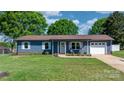 Well-maintained home boasting lush lawn, inviting front porch, and attached one car garage at 2430 Rocky Ford Rd, Newton, NC 28658