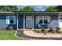 Inviting front porch with rocking chairs and fresh landscaping enhances the curb appeal of this lovely home at 2430 Rocky Ford Rd, Newton, NC 28658