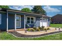 Charming home featuring rocking chairs on the cozy front porch and an attached one car garage at 2430 Rocky Ford Rd, Newton, NC 28658