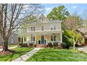 Charming two-story home featuring a welcoming front porch and a beautifully landscaped front yard at 2569 Lower Assembly Dr, Fort Mill, SC 29708