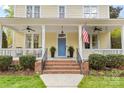 Inviting front porch with classic details and ceiling fans at 2569 Lower Assembly Dr, Fort Mill, SC 29708