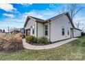 Inviting home exterior showcasing tidy landscaping, neutral tones, and a driveway at 322 Flat Rock Dr, Denver, NC 28037