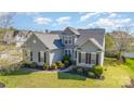 Charming two-story home with manicured lawn, gray siding, black shutters, and lush landscaping at 408 Harvest Ter, Clover, SC 29710