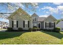 Charming two-story home with manicured lawn, gray siding, black shutters, and lush landscaping at 408 Harvest Ter, Clover, SC 29710