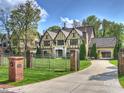 Beautiful home with manicured lawn, wrought iron fence and attached garage at 4400 Sharon View Rd, Charlotte, NC 28226