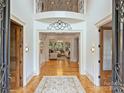 Grand foyer with high ceilings, detailed trim, and hardwood floors at 4400 Sharon View Rd, Charlotte, NC 28226