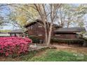 Beautiful waterfront home with mature landscaping and flowering bushes at 477 Big Indian Loop, Mooresville, NC 28117