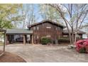 Charming two-story waterfront home with a covered carport and mature trees at 477 Big Indian Loop, Mooresville, NC 28117