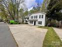 Exterior view of a two-story home with a large concrete driveway and lawn at 4927 Curtiswood Dr, Charlotte, NC 28213