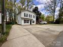 Charming two-story home with black shutters and large concrete driveway at 4927 Curtiswood Dr, Charlotte, NC 28213
