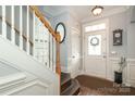 Welcoming entryway featuring tile flooring, staircase, and elegant decor at 5121 Alysheba Dr, Indian Trail, NC 28079