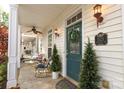 Inviting front porch with seating, decorative wreath, and charming exterior details at 5121 Alysheba Dr, Indian Trail, NC 28079