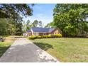 Well-maintained home featuring a long driveway and a cozy, landscaped front yard at 5762 Hightower Rd, Fort Lawn, SC 29714