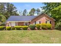 Inviting brick home showcasing manicured bushes and black shutters for a cozy, classic appeal at 5762 Hightower Rd, Fort Lawn, SC 29714