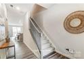 Entryway view of staircase with wooden railing and modern decor at 7144 Hodges Meadow Ln, Charlotte, NC 28213
