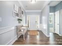 Inviting home entry with hardwood floors, bench seating and decorative wall art at 108 Toxaway St, Mooresville, NC 28115