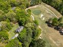 Aerial view of a golf course community featuring lush greenery and meticulously maintained fairways at 1116 Landons Ct, China Grove, NC 28023