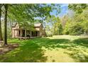 Spacious backyard with a covered porch, providing a serene outdoor living space and lush lawn at 1116 Landons Ct, China Grove, NC 28023