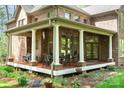 Covered porch with outdoor dining set, perfect for relaxing and enjoying the beautiful surroundings at 1116 Landons Ct, China Grove, NC 28023