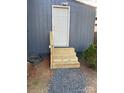 Exterior view of the rear entrance with wooden steps and a white door at 113 Hideaway Trl, Mount Gilead, NC 27306