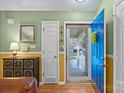 Bright foyer featuring a blue front door, wooden floors, and decorative accents at 117 Heath Ln, Mooresville, NC 28117