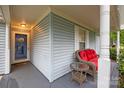 Inviting front porch area featuring a wicker sofa and small table at 117 Heath Ln, Mooresville, NC 28117