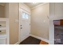 Bright foyer features a white door, hardwood floors, and neutral paint that complement a marble fireplace at 1545 Wimbleton Woods Dr, Fort Mill, SC 29708