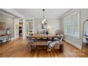 Bright dining room with a wooden table set, chandelier, and window views at 1801 Wilmore Dr, Charlotte, NC 28203
