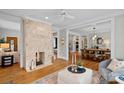 Spacious living room featuring a stone fireplace and hardwood floors at 1801 Wilmore Dr, Charlotte, NC 28203