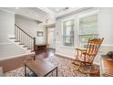 Cozy foyer featuring hardwood floors, a staircase, and natural light from large windows at 190 Silverspring Pl, Mooresville, NC 28117