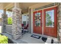 Inviting front porch with a double door entrance, stone pillars, and outdoor seating at 190 Silverspring Pl, Mooresville, NC 28117