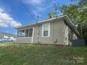 Charming single-story home with neutral siding, screened porch, and well-maintained lawn at 211 W 2Nd St, Kershaw, SC 29067