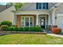 Charming front yard featuring manicured landscaping, brick accents and large windows at 2136 Ashley River Rd, Waxhaw, NC 28173