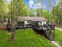 Spacious back deck with black railings and stairs, overlooking a large, well-maintained yard at 214 Creek View Rd, Mooresville, NC 28117