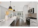 Bright, well-appointed kitchen with stainless steel appliances, stone countertops, and an open view to the living area at 218 Lacewing Dr # 41, Charlotte, NC 28214