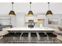 Modern kitchen featuring a large island with bar seating, pendant lighting, white cabinets, and stainless steel appliances at 218 Lacewing Dr # 41, Charlotte, NC 28214