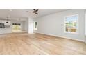 Sunlit living room featuring hardwood floors and large windows overlooking the backyard at 2512 Remington St, Charlotte, NC 28216