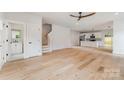 Bright open-plan living space featuring hardwood floors and a modern kitchen with stainless steel appliances at 2512 Remington St, Charlotte, NC 28216