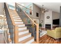 Inviting living room featuring vaulted ceilings, a fireplace, and an open staircase leading to a second floor loft at 2532 Annecy Dr, Matthews, NC 28105
