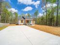 Charming single-story home featuring a light gray exterior, vibrant blue front door, and lovely landscaping at 297 Barr Link Rd, Mount Pleasant, NC 28124
