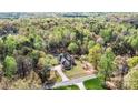 Aerial view of house surrounded by lush trees and featuring a pool at 3207 Oak Ridge Cir, Lincolnton, NC 28092