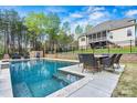 Beautiful backyard pool with an outdoor dining area and a view of the home's screened in porch at 3207 Oak Ridge Cir, Lincolnton, NC 28092