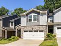 Charming townhouse with a two-car garage, stone accents, and manicured landscaping at 3524 Auburn Curb Rd, Charlotte, NC 28217