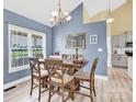 Bright dining room with a large window, stylish table set, a view of the kitchen and modern flooring at 365 Kinder Rd, Harmony, NC 28634